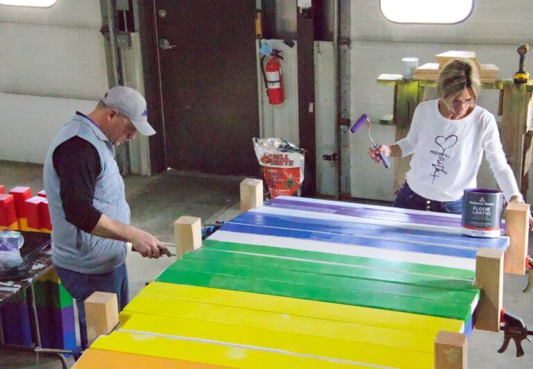 City cemetery manager Ryan Smith and Barb Grosz paint parts of a rainbow bridge that will eventually be placed in the new pet burial area at Riverside Memorial Cemetery. Aberdeen Insider photo by Elisa Sand.