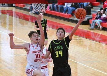 Aberdeen Roncalli's Jesse Hernandez scores on a layup off a steal during the first quarter of a Region 1A game against Britton-Hecla Tuesday, March 3 in Britton. Defending for the Braves is Lofton Heer. Hernandez scored 22 points, but Britton-Hecla got the win 59-54. Aberdeen Insider photo by Robb Garofalo.