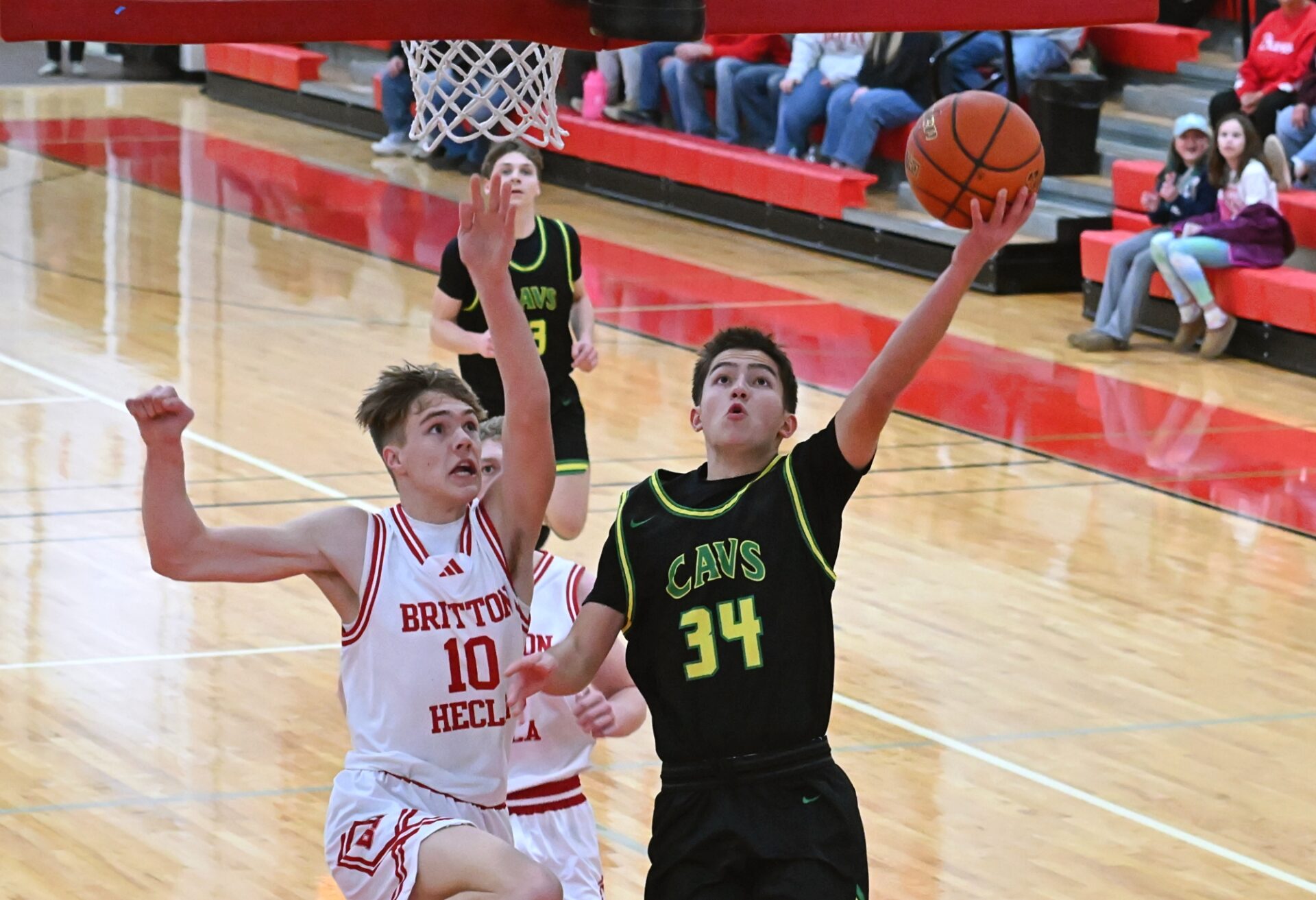 Aberdeen Roncalli's Jesse Hernandez scores on a layup off a steal during the first quarter of a Region 1A game against Britton-Hecla Tuesday, March 3 in Britton. Defending for the Braves is Lofton Heer. Hernandez scored 22 points, but Britton-Hecla got the win 59-54. Aberdeen Insider photo by Robb Garofalo.
