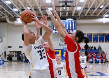 Aberdeen Central's Lauryn Burckhard goes up for a shot against Rapid City Central's Chloe Shreve during the third quarter of their Class AA SoDak 16 game Friday, March 6 inside Golden Eagles Arena. Burckhard scored a team high 14 points in a 55-38 win. Central advanced to the Class AA State Tournament beginning Thursday, March 12 in Rapid City. Aberdeen Insider photo by Robb Garofalo.