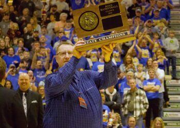 Castlewood head coach Paul Raasch holds up the Class B State Boys Basketball Tournament championship trophy after his Warriors defeated Viborg-Hurley in the 2025 State B title game. Raasch will be inducted into the South Dakota High School Basketball Coaches Association's Hall of Shrine and will be recognized during this year's State B tournament. Aberdeen Insider photo by Robb Garofalo.
