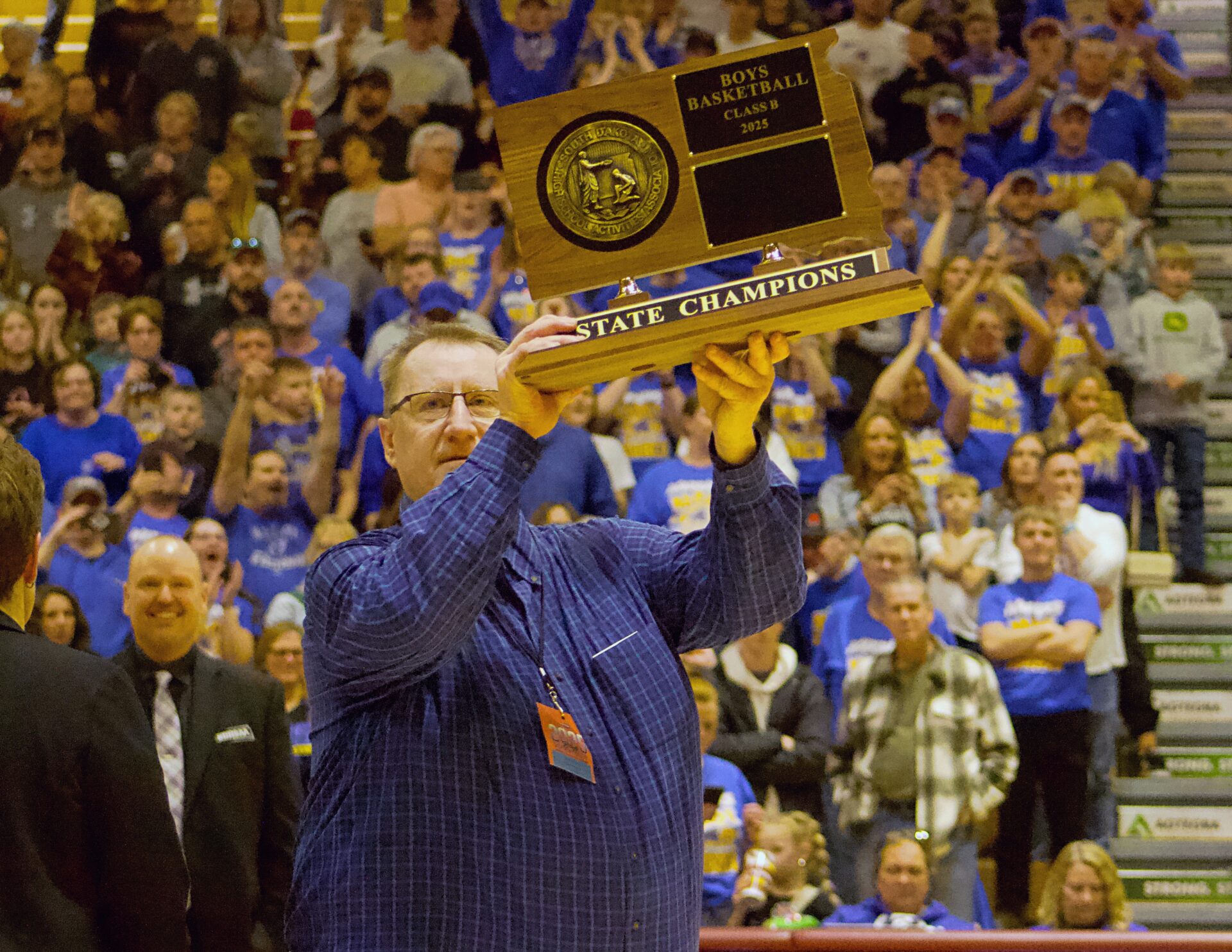 Castlewood head coach Paul Raasch holds up the Class B State Boys Basketball Tournament championship trophy after his Warriors defeated Viborg-Hurley in the 2025 State B title game. Raasch will be inducted into the South Dakota High School Basketball Coaches Association's Hall of Shrine and will be recognized during this year's State B tournament. Aberdeen Insider photo by Robb Garofalo.