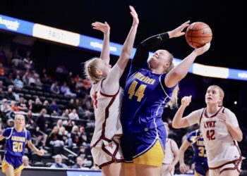 Taryn Hermansen of Aberdeen Central goes up for a shot against Brandon Valley's Gwendolyne Lease during a semifinal game in the Class AA girls high school basketball tournament Friday, March 13 in Rapid City. The Lynx won the game to advance to the championship. Hermansen was named to the all-tournament team. Photo courtesy of South Dakota Public Broadcasting.