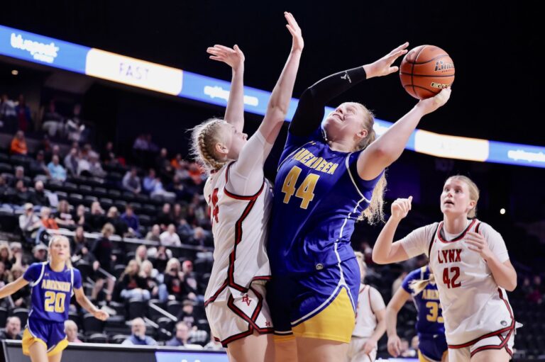 Taryn Hermansen of Aberdeen Central goes up for a shot against Brandon Valley's Gwendolyne Lease during a semifinal game in the Class AA girls high school basketball tournament Friday, March 13 in Rapid City. The Lynx won the game to advance to the championship. Hermansen was named to the all-tournament team. Photo courtesy of South Dakota Public Broadcasting.