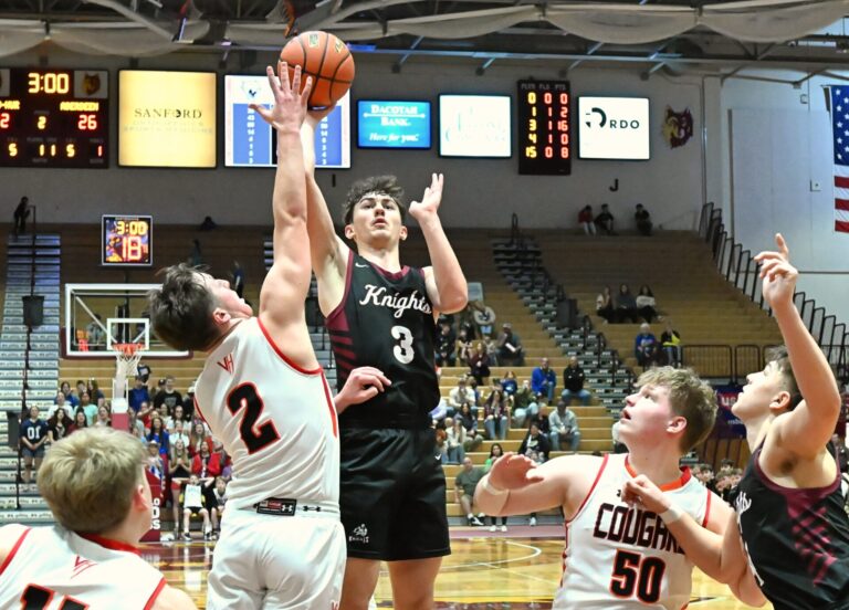 Aberdeen Christian's Luke Kaiser takes a shot over Viborg-Hurley's Brenner Gerdes during their consolation semifinal at the Class B Boys State Tournament Friday, March 20 inside the Barnett Center. Kaiser had 26 points in a 52-49 win. Aberdeen Insider photo by Robb Garofalo.