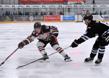 Aberdeen forward Tevan James reaches for the puck while being defended by St. Cloud's Avry Shaw Saturday, March 28 inside the Odde Ice Center. The Norsemen skated to a 5-1 win and swept the weekend series. Aberdeen Insider photo by Robb Garofalo.