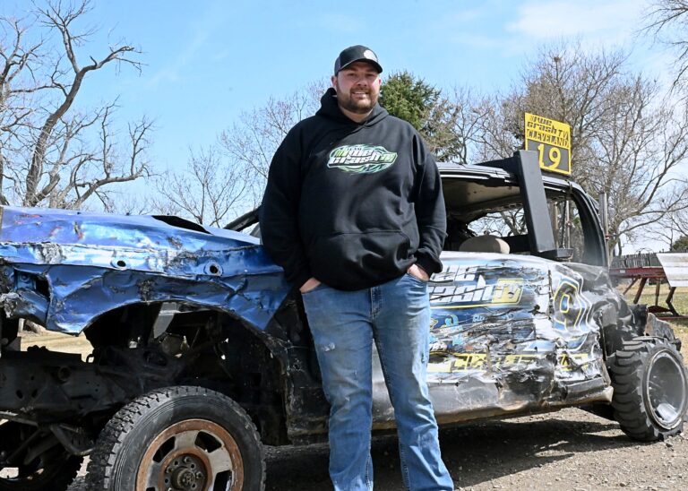 Aberdeen's Derek Cleveland leans against his demolition derby car that helped him and three other drivers win the Cornhusker Chaos four-man derby Saturday, Feb. 7 in Grand Island, Neb. Aberdeen Insider photo by Robb Garofalo.