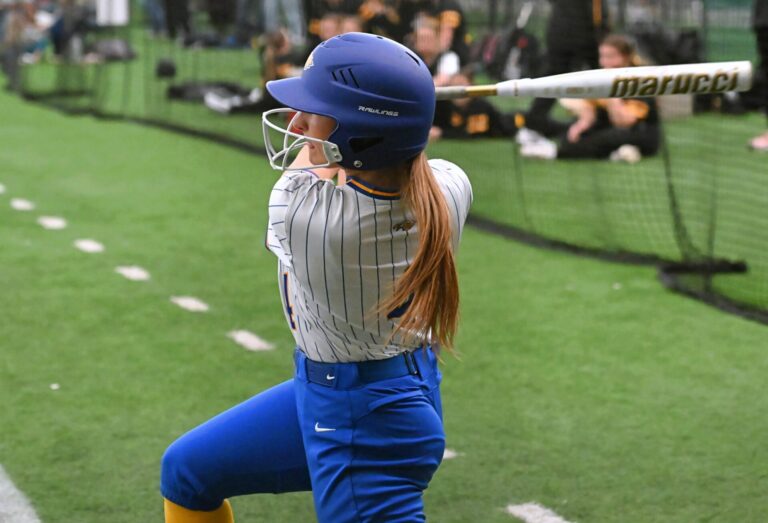 Aberdeen Central's Kylla Aesoph finishes her swing during game one of Central's doubleheader against Groton Area Thursday, April 2 inside the Aberdeen Dome. Central swept both games, winning game one 9-8 and game two 6-3. Aberdeen Insider photo by Robb Garofalo.