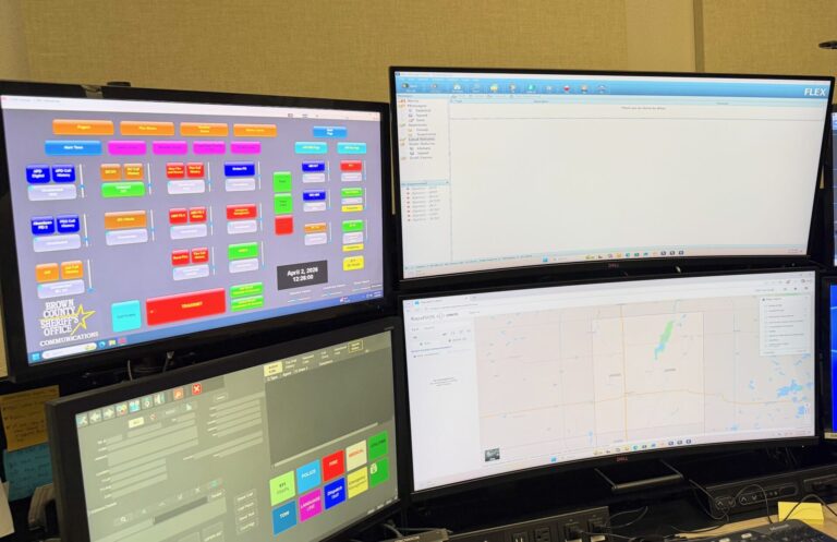 Brown County dispatchers answer calls from a station featuring three computers networked together with information displayed on six monitors. Four of those monitors are pictured in this photo. Aberdeen Insider photo by Elisa Sand.
