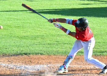 Jehiel Aviles of the Aberdeen Smittys reaches out and makes contact during 2025 game against Pierre at Fossum Field. Aberdeen Insider photo by Robb Garofalo.