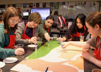 Holgate Middle School eighth-graders paint a portion of the Leadership Aberdeen mural that will be on display at the K.O. Lee Aberdeen Public Library. Youth Power students who are painting include, from left, Lennon Bunke, Luci Blazer, Eleanore Cavanaugh, Serenity Kuntz, Charissa End of Horn and Madilynn Davis. Aberdeen Insider photo by Elisa Sand.