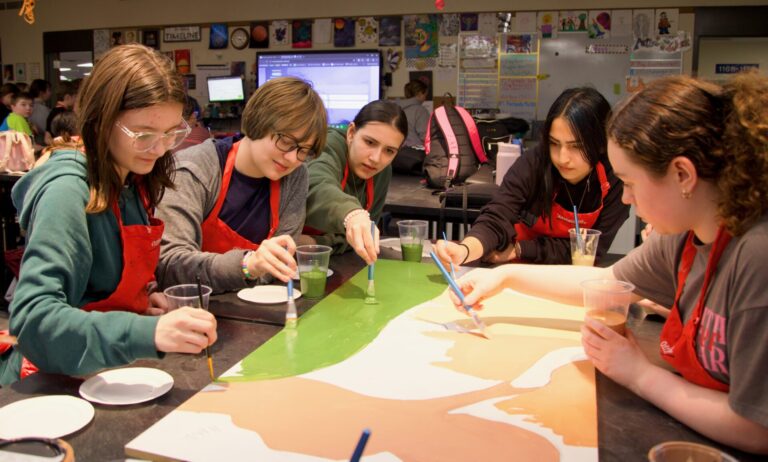 Holgate Middle School eighth-graders paint a portion of the Leadership Aberdeen mural that will be on display at the K.O. Lee Aberdeen Public Library. Youth Power students who are painting include, from left, Lennon Bunke, Luci Blazer, Eleanore Cavanaugh, Serenity Kuntz, Charissa End of Horn and Madilynn Davis. Aberdeen Insider photo by Elisa Sand.