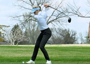 Aberdeen Central's Olivia Braun leans into her tee shot during the Hub City Invitational Thursday, May 1, 2025, at Lee Park Golf Course. She's the defending state champion in Class AA. The Golden Eagles also won the team title. Aberdeen Insider photo by Robb Garofalo.