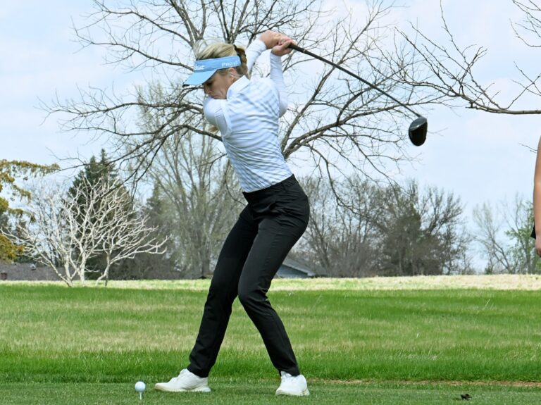 Aberdeen Central's Olivia Braun leans into her tee shot during the Hub City Invitational Thursday, May 1, 2025, at Lee Park Golf Course. She's the defending state champion in Class AA. The Golden Eagles also won the team title. Aberdeen Insider photo by Robb Garofalo.