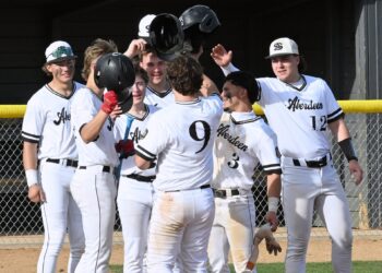 Members of the Aberdeen Smittys celebrate with teammate Levi Hoffman (9) after his two-run home run in game one of the Smittys doubleheader against Pierre Thursday, April 16 at Fossum Field. Pierre won both games. Aberdeen Insider photo by Robb Garofalo.