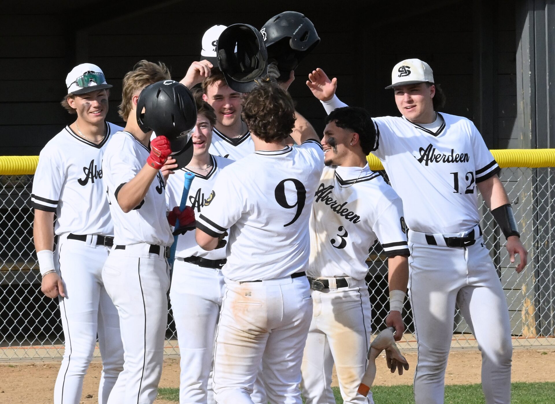 Members of the Aberdeen Smittys celebrate with teammate Levi Hoffman (9) after his two-run home run in game one of the Smittys doubleheader against Pierre Thursday, April 16 at Fossum Field. Pierre won both games. Aberdeen Insider photo by Robb Garofalo.