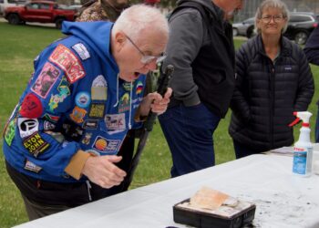 Stephen Bakken takes a peek at the contents of the box he packed 50 years ago for the Zonta Club time capsule. The capsule was opened Saturday, April 25 at Melgaard Park. It was a kickoff to America250 events in Aberdeen. Aberdeen Insider photo by Elisa Sand.