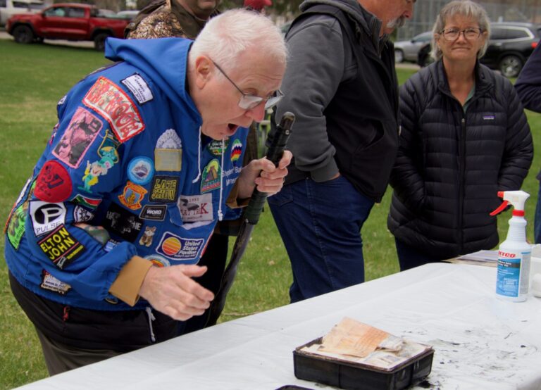 Stephen Bakken takes a peek at the contents of the box he packed 50 years ago for the Zonta Club time capsule. The capsule was opened Saturday, April 25 at Melgaard Park. It was a kickoff to America250 events in Aberdeen. Aberdeen Insider photo by Elisa Sand.
