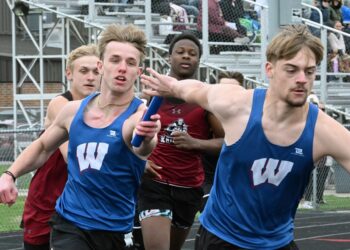 Warner's Jesiah Baum hands the baton to teammate Brennan Wolf-Donat in the boys 400-meter relay during the Rob Luecke Invitational Tuesday, April 28 at Doney Field in Groton. Behind them are Aberdeen Christian's Bryan Ekanger, left, and Loyall Smith-Wade. Aberdeen Insider photo by Robb Garofalo.