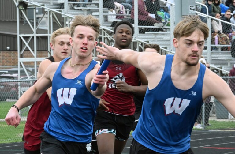 Warner's Jesiah Baum hands the baton to teammate Brennan Wolf-Donat in the boys 400-meter relay during the Rob Luecke Invitational Tuesday, April 28 at Doney Field in Groton. Behind them are Aberdeen Christian's Bryan Ekanger, left, and Loyall Smith-Wade. Aberdeen Insider photo by Robb Garofalo.