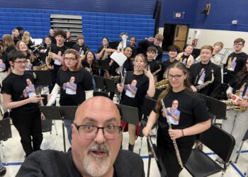 Simmons Middle School band students honored their director James Panerio with special shirts during his final concert earlier this spring. Each shirt had an image of Panerio playing that student's instrument. Panerio is retiring at the end of the school year. Courtesy photo.
