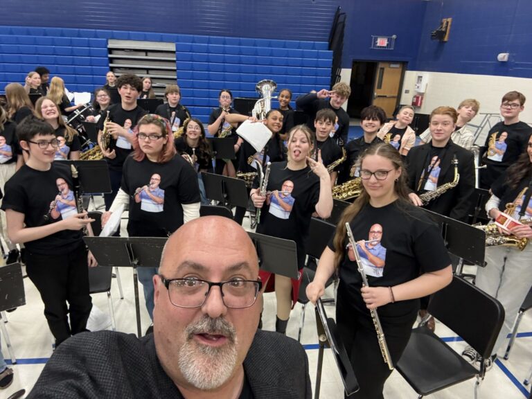 Simmons Middle School band students honored their director James Panerio with special shirts during his final concert earlier this spring. Each shirt had an image of Panerio playing that student's instrument. Panerio is retiring at the end of the school year. Courtesy photo.