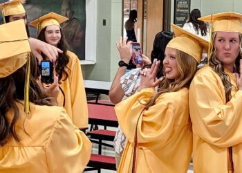 Roncalli High School seniors Gianna Madsen, left, and Reese Heinrich pose for a photo before the start of their graduation ceremony on Saturday, May 16 at Roncalli High School. Aberdeen Insider photo by Scott Waltman.