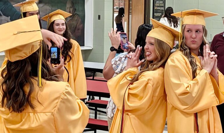 Roncalli High School seniors Gianna Madsen, left, and Reese Heinrich pose for a photo before the start of their graduation ceremony on Saturday, May 16 at Roncalli High School. Aberdeen Insider photo by Scott Waltman.