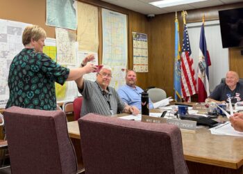 Brown County Auditor Lynn Heupel holds a bowl so County Commissioner Mike Wiese can draw a random race for an audit of the June 2 primary election, while commissioners Mike Gage, center, and Duane Sutton watch. Aberdeen insider photo by Elisa Sand.