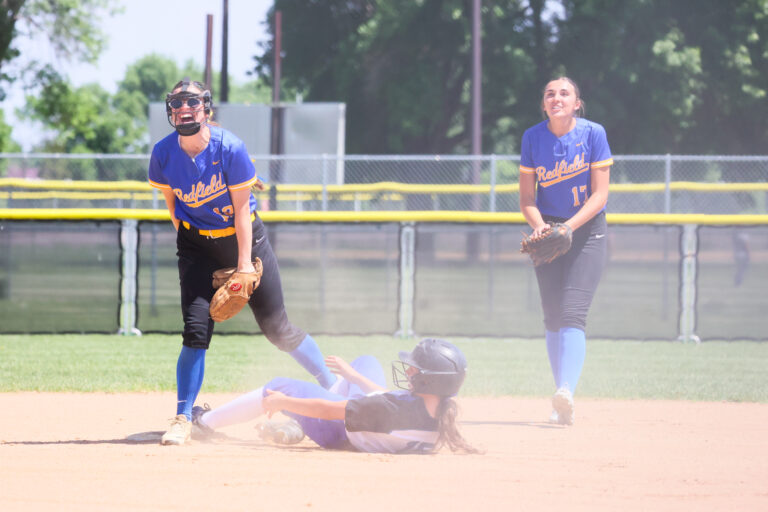 Redfield second baseman, left, Layla Hardie/centerfielder Hayden Gall celebrate after recording an out during the consolation semifinals against Florence/Henry on Friday, June 5 at the Class B state softball tournament at Players Complex in Aberdeen. The Pheasants won 7-6 to advance to the fifth-place game. Freeman Courier photo courtesy of Jeremy Waltner.