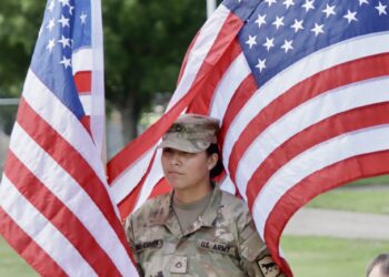 Gallery: Families, flag, fun invade Wylie Park for weekend 4 Azlyn Dwarf-Heminger of Aberdeen, a member of the South Dakota National Guard 740th Transportation Co., is surrounded by American flags during a ceremony on Friday, June 5 at Wylie Park. South Dakota's America250 flag raise raised during the event and was on display during the weekend before it was sent to Sioux Falls. Aberdeen Insider photo by Scott Waltman.