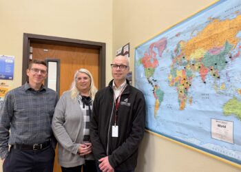 Staff at Cornerstones Career Learning Center in Aberdeen are, from left, Daniel Justice, adult basic education instructor; Jennifer Wagemann, co-program coordinator; and Jeremy Storly, co-program coordinator. They are standing in front of a map in the office showing the home of students who have taken classes. Aberdeen Insider photo by Elisa Sand.