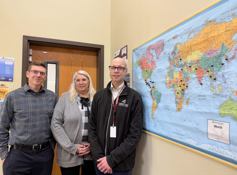 Staff at Cornerstones Career Learning Center in Aberdeen are, from left, Daniel Justice, adult basic education instructor; Jennifer Wagemann, co-program coordinator; and Jeremy Storly, co-program coordinator. They are standing in front of a map in the office showing the home of students who have taken classes. Aberdeen Insider photo by Elisa Sand.
