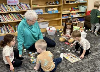 A local grandparent helps out with a summer reading program for kids at the Doland Community Library. Courtesy photo.