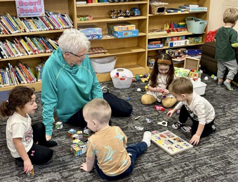A local grandparent helps out with a summer reading program for kids at the Doland Community Library. Courtesy photo.