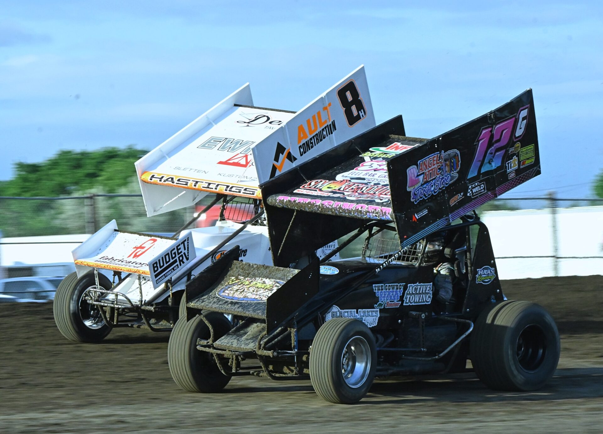 Watertown's Kinzlee Giessinger (12G) tries to pass Jade Hastings of East Grand Forks, Minn., on the back straightaway during their NOSA Sprints heat race Friday, June 26 at the Brown County Speedway. Aberdeen Insider photo by Robb Garofalo.