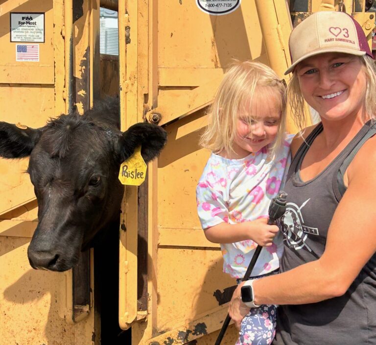 Jamie Hart with her niece Paislee Hart and one of the Hart Simmentals near Frederick. Jamie was badly injured by a cow in February, but is on the mend. Courtesy photo.