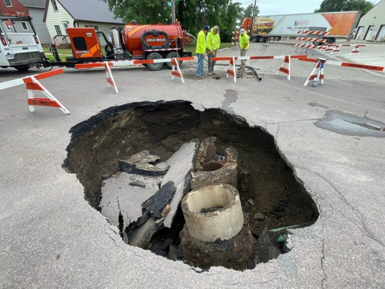 A portion of a road collapsed as the result of a thunderstorm the night of Tuesday, July 7. City crews are working to fix the significant hole. Photo courtesy of Travis Schaunaman.