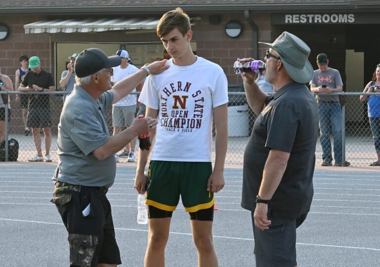 Terry Dosch, left, goes over some adjustments to be made by Parker Grieben during the 2024 Al Sahli Invitational track and field meet in Aberdeen. In on the conversation is Roncalli's Mark Stone. Dosch is being inducted into the South Dakota Coaches Association Hall of Fame. Aberdeen Insider photo by Robb Garofalo.