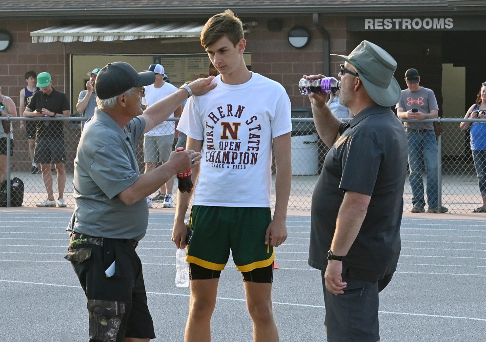 Terry Dosch, left, goes over some adjustments to be made by Parker Grieben during the 2024 Al Sahli Invitational track and field meet in Aberdeen. In on the conversation is Roncalli's Mark Stone. Dosch is being inducted into the South Dakota Coaches Association Hall of Fame. Aberdeen Insider photo by Robb Garofalo.