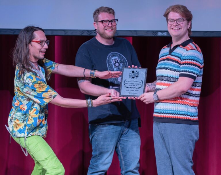 Recipients of best film and the Dr. Kane Anderson awards during the ReelRoad48 Short Film Festival last weekend were, from left, Trea LeBeau and Anthony Ulrich. Presenting the Dr. Kane Anderson Award is  event organizer John Schwab, on the right. Photo courtesy of John Schwab.