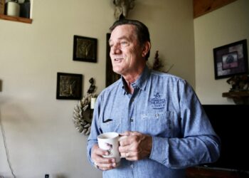 South Dakota Gov. Larry Rhoden drinks a cup of coffee on June 26 in the living room at his ranch near Union Center. South Dakota Searchlight photo by Makenzie Huber.