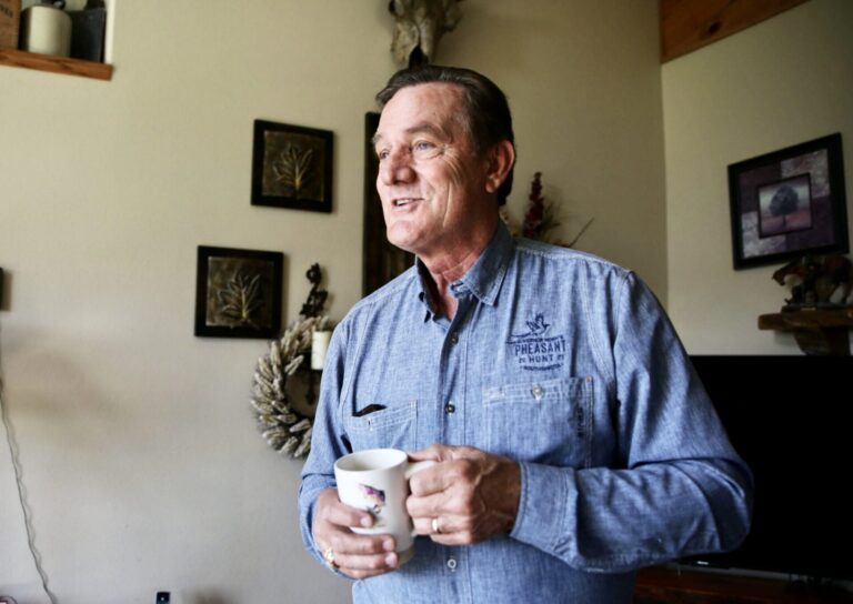 South Dakota Gov. Larry Rhoden drinks a cup of coffee on June 26 in the living room at his ranch near Union Center. South Dakota Searchlight photo by Makenzie Huber.