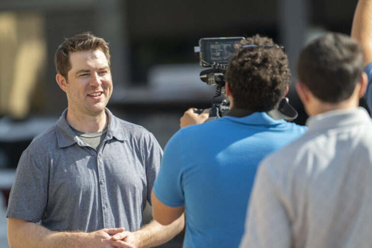 Tim Davidson, the host of the South Dakota Public Broadcasting show "Dakota Life" is filmed in downtown Aberdeen while working on an episode that will air in fall. Aberdeen Insider photo by Troy McQuillen.
