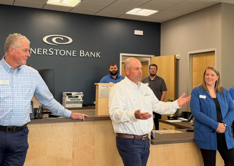 Ryan Schimke, center, Cornerstone Bank market president, speaks about Cornerstone prior to a ribbon-cutting event on Thursday, July 23 in Aberdeen. At left is CEO Jeff Thomas and to the right is local banking associate Tonya Smith. Aberdeen Insider photo by Elisa Sand.