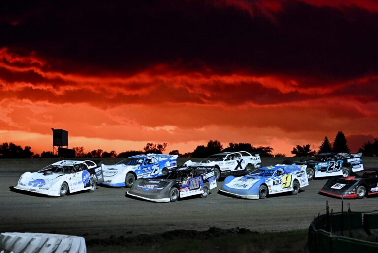 Drivers in the Late Model class approach the start line for a heat race during the Dacotah Rumble Saturday, July 25 at Brown County Speedway. A severe thunderstorm replaced the fire-orange sunset, leading to some races being canceled. Aberdeen Insider photo by Robb Garofalo.