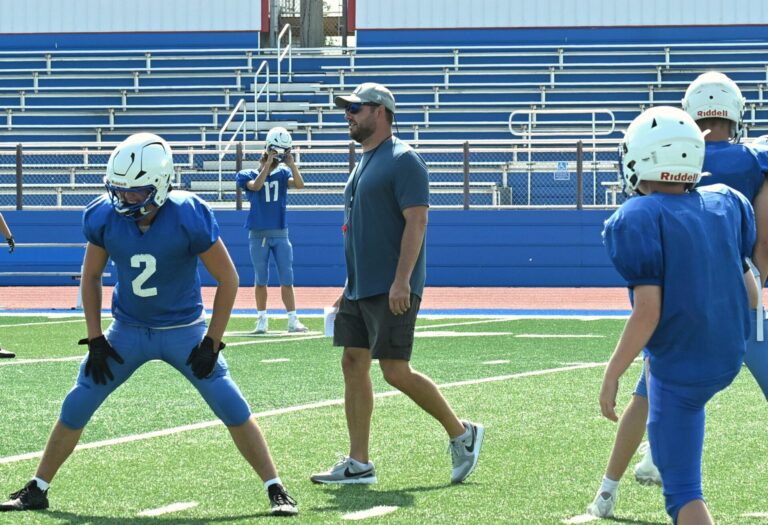 Warner head football coach Derek Hoellein watches his team stretch before practice on Monday, Aug. 17 at BankNorth/Dial-A-Move Field in Warner. The Monarchs open their season Friday, Aug. 21 against Northwestern in Mellette. Aberdeen Insider photo by Robb Garofalo.