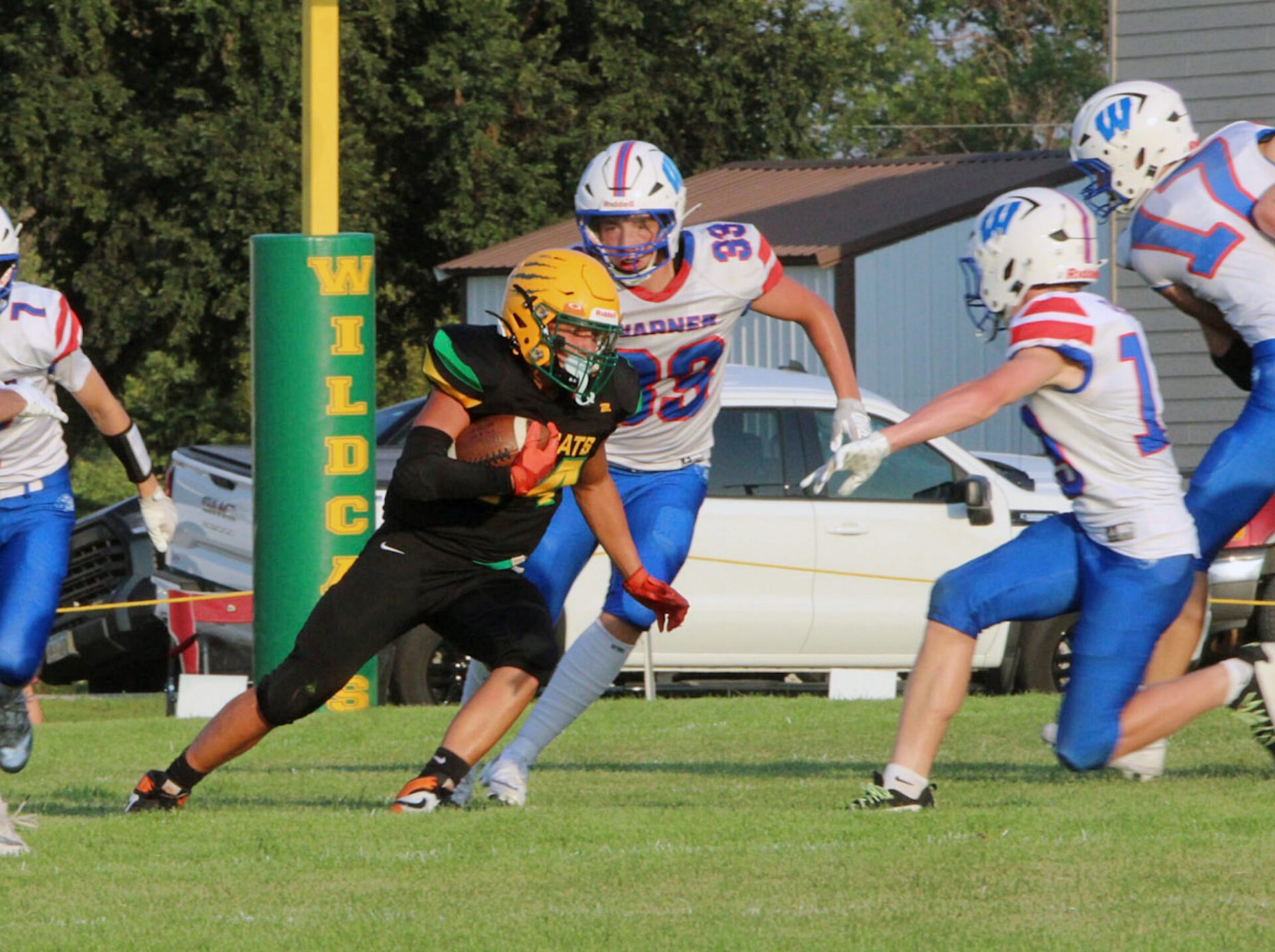 Northwestern's Talon Miller looks for running room against Warner's Gage Knuppe (33), Beckham Cantalope and Lincoln Kroll (17) during their game Friday, Aug. 21 in Mellette. Miller had 97 yards rushing and a touchdown for the Wildcats. Aberdeen Insider photo by Allie Hoekman.