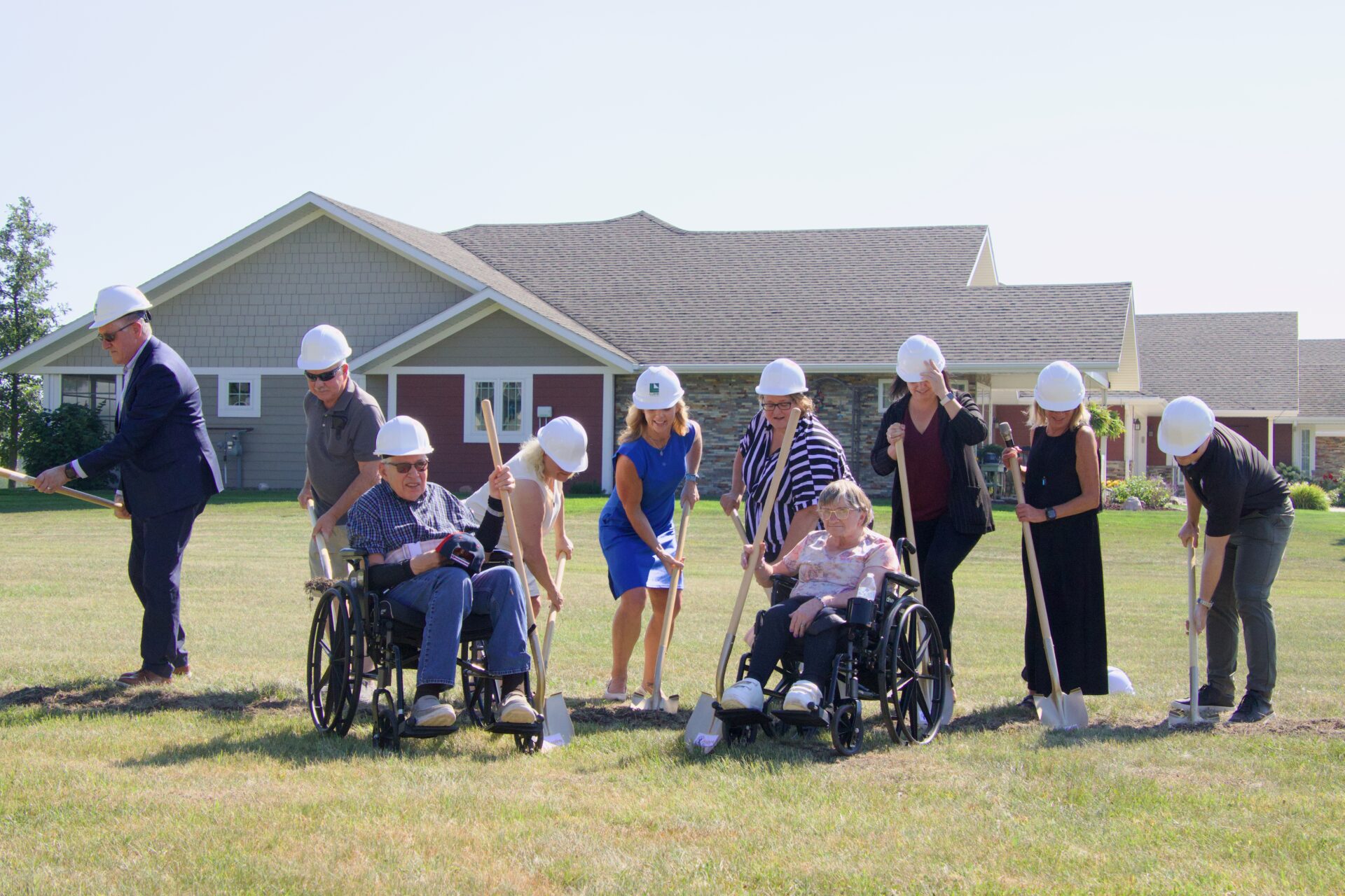 Those who attended a Thursday, Aug. 27 groundbreaking ceremony for two new duplexes being built for Aspire included, back from left, Deputy Mayor Alan Johnson, donor family representatives Terry Ellingson and Vicki Bierschbach, Aspire Board President Robyn Ewalt, Aspire Executive Director Jennifer Gray, Aspire Foundation Board President Rebecca Ronayne, Aspire Development Director Janae Hamilton and Luke Wietgrefe from Lloyd Design Group. In front are Denis Heidenreich and Melanie Stromseth, two of 135 people who receive support services from Aspire. Aberdeen Insider photo by Elisa Sand.