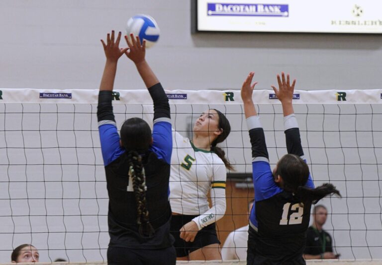 Aberdeen Roncalli's Gabby Thomas attempts to hit the ball over the block attempt of Tiospa Zina's Brileigh Bartunek, left, and Stevie Marks Thursday, Sept. 3 at the Roncalli Gym. The Cavaliers won in three sets. Aberdeen Insider photo by Allie Hoekman.